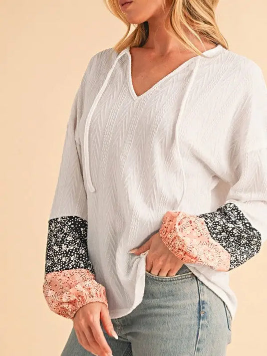 White textured long-sleeve top with floral patchwork balloon sleeves for stylish comfort