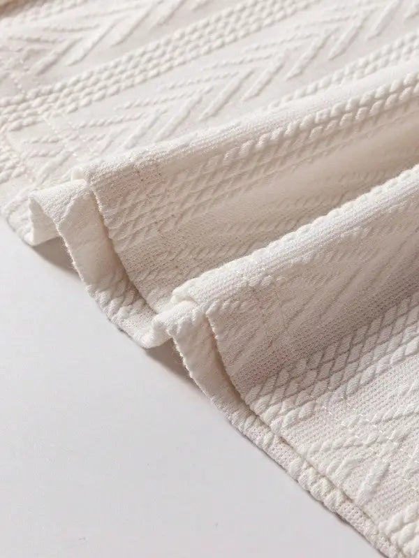 White textured fabric with woven patterns from the Floral Patchwork Top collection