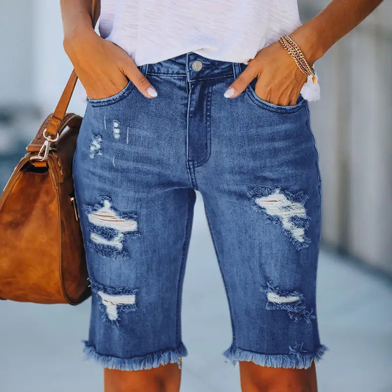 Distressed blue denim Bermuda shorts with ripped holes and fringed high elasticity hem