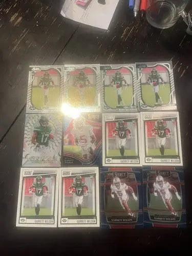 Collection of football trading cards featuring Garrett Wilson rookie cards and player designs