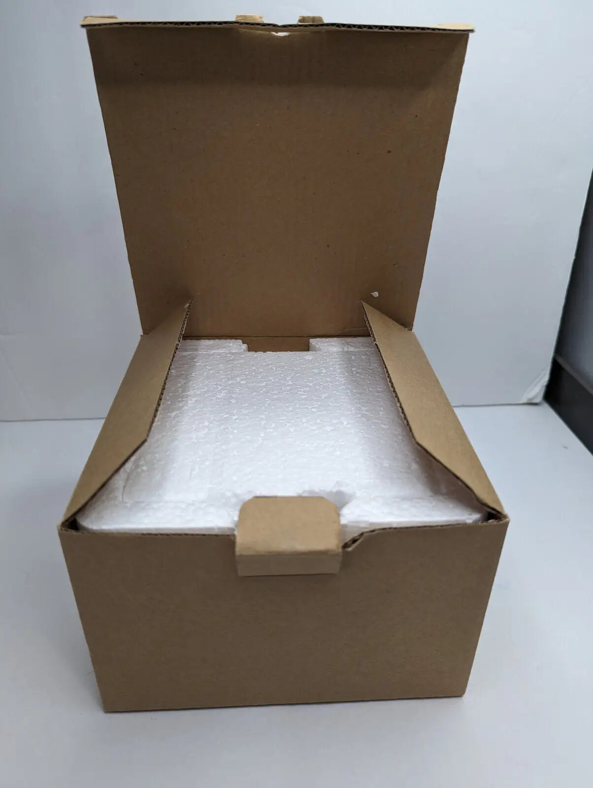 Open cardboard box with foam padding for Gold Canyon Votive Pillar Candle Holders set