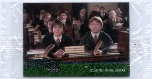 Two students in robes at a desk with Harry Potter trading cards from the silver foil promo set