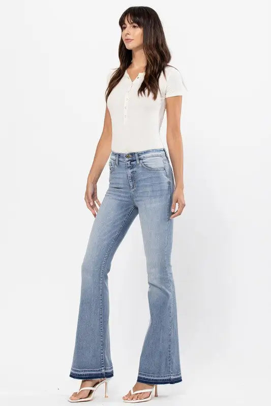 Light-wash high rise flare jeans with distressed details and raw cut hem