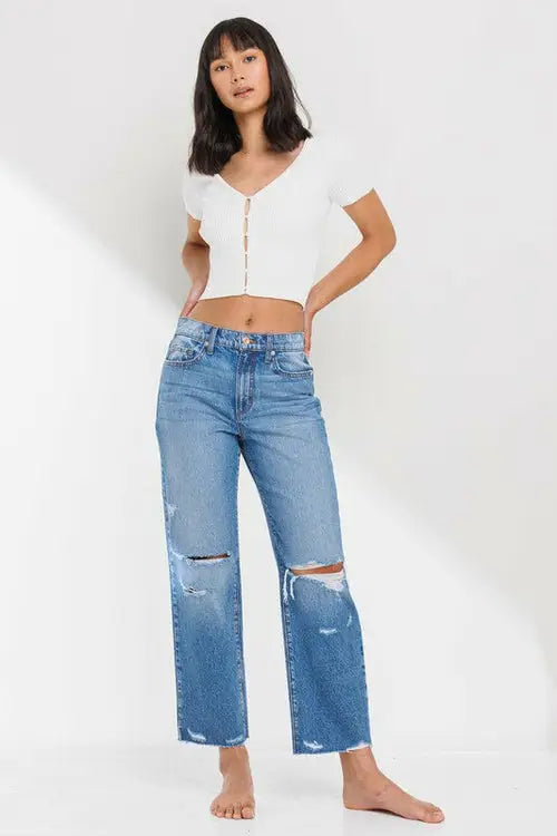 Woman wearing high rise straight leg ankle jean with raw hem in casual fashion style
