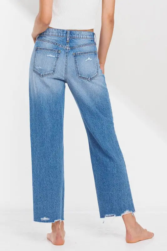 Women’s high-rise straight leg light-wash denim jeans with distressed details and raw hem