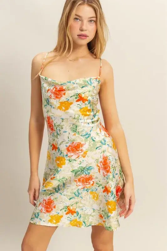 Woman wearing HYFVE floral cowl neck mini dress in satin fabric