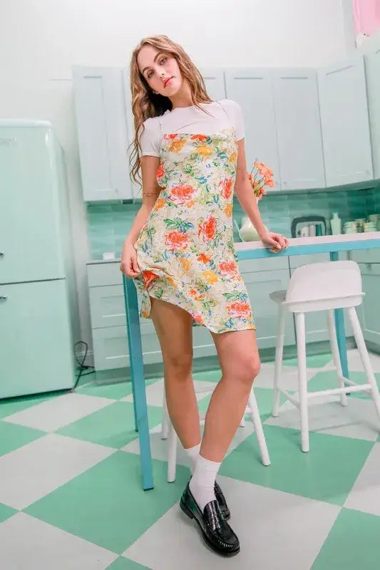 Woman wearing HYFVE Floral Cowl Neck Flirty Satin Mini Dress with white t-shirt and loafers