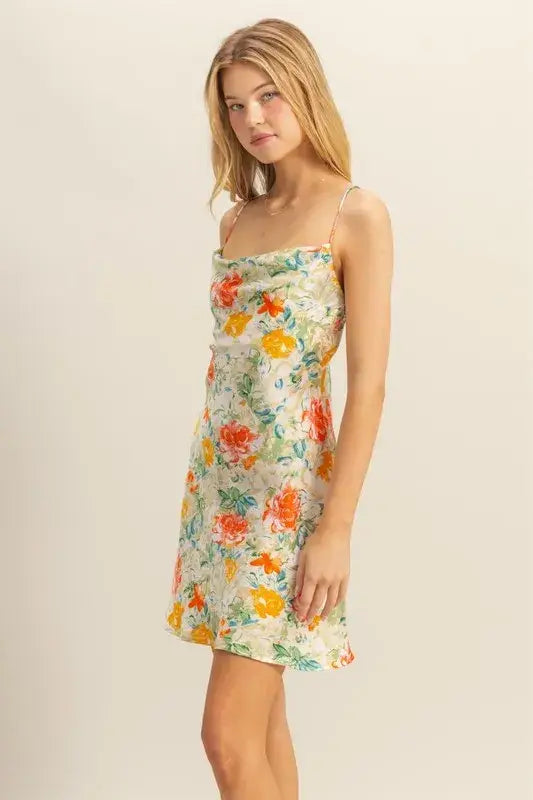 Young woman in HYFVE Floral Cowl Neck Flirty Satin Mini Dress with spaghetti straps