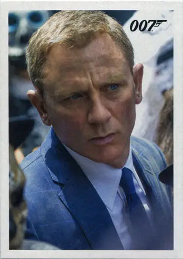 Close-up of a serious man in a blue suit with the 007 logo for James Bond trading cards