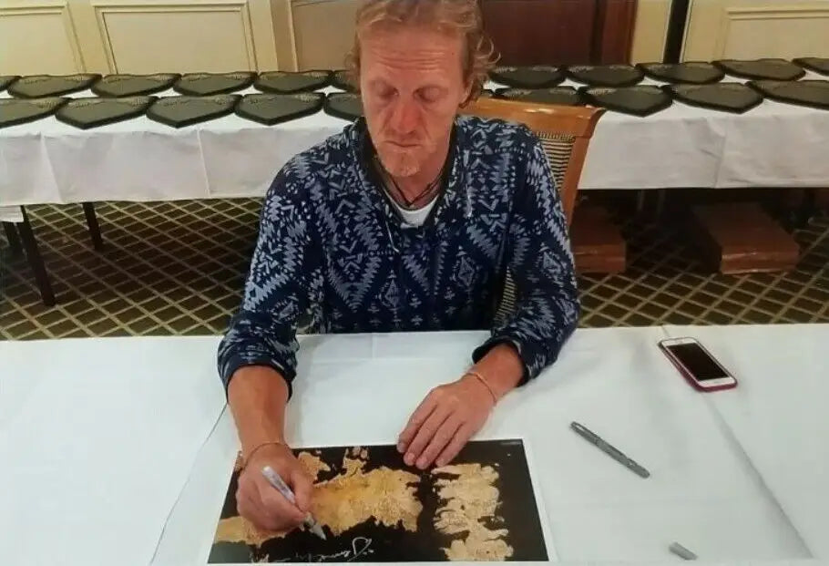 Man signing a Jerome Flynn Bronn signed Westeros map 11x17 photo for Radtke COA