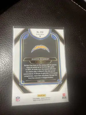 Justin Herbert Los Angeles Chargers trading card with red yellow shock and yellow shock prizm design