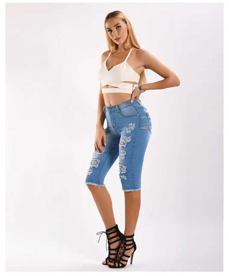 Light blue distressed denim capri jeans with ripped details from Knee Length Destroyed Ripped Jeans