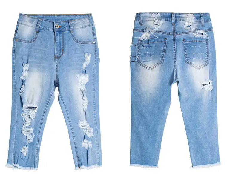 Light-wash distressed denim capri jeans with frayed hems, perfect for destroyed ripped jeans style