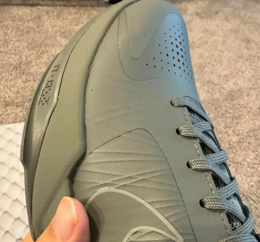 Gray Kobe 5 Fade To Black athletic shoe with textured panels and eyelets for fast shipping