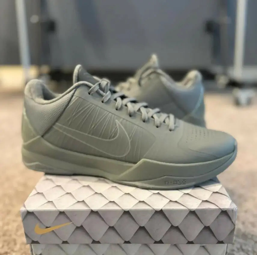 Monochromatic light green-grey Kobe 5 Fade To Black athletic shoes with Nike swoosh, fast shipping