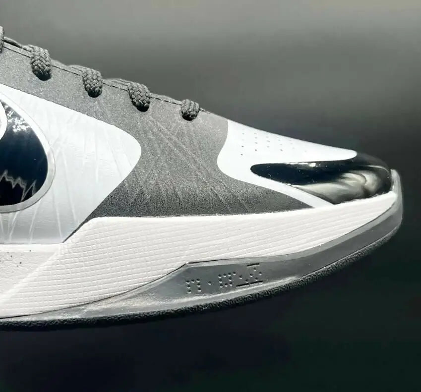 Gray and white Kobe 5 Protro Panda athletic shoe with black Nike swoosh and glossy toe cap