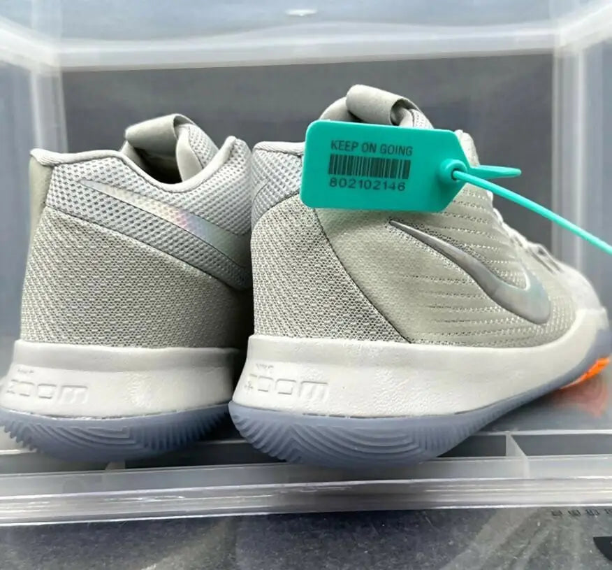 Light grey Kyrie 3 White athletic shoes with white midsoles and green security tag for fast shipping