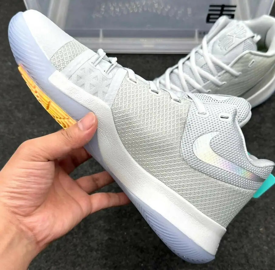 Light grey Nike Kyrie 3 White athletic shoes with iridescent swooshes and translucent sole for fast shipping