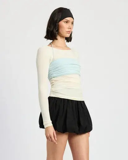 Trendy long sleeve cream top with light blue ruched bandeau overlay and black bubble skirt