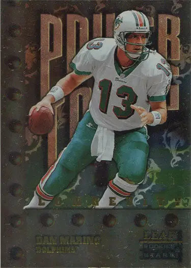 Football player in Miami Dolphins uniform holding football on Leaf Rookies Dan Marino card