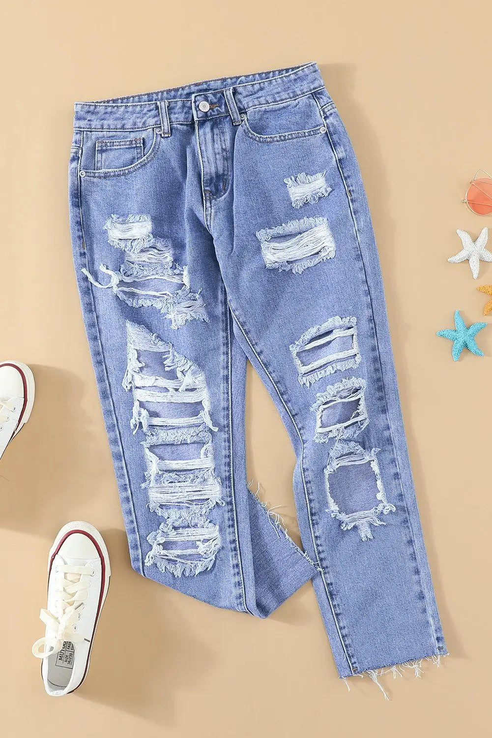 Light wash skinny jeans for women with distressed details, ripped knees and thighs