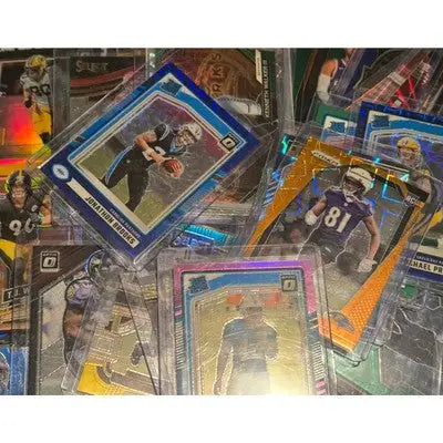 Football card lot with trading cards in protective sleeves and top loaders