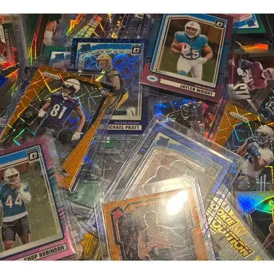 Pile of various football trading cards in a football card lot with top loaders