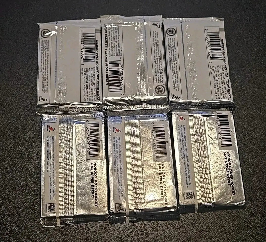 Six unopened Upper Deck hockey card packs from the 1990-91/1991-92 series