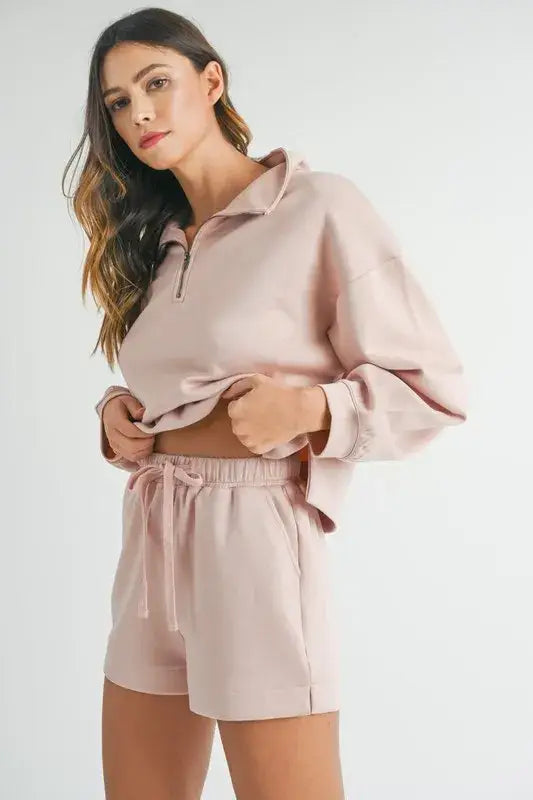 Dusty rose-colored two-piece loungewear set with half zip sweatshirt and shorts for women