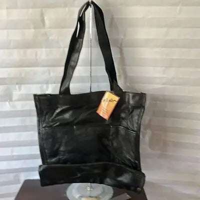 Maxam Black leather tote bag with shoulder straps and orange tag for women