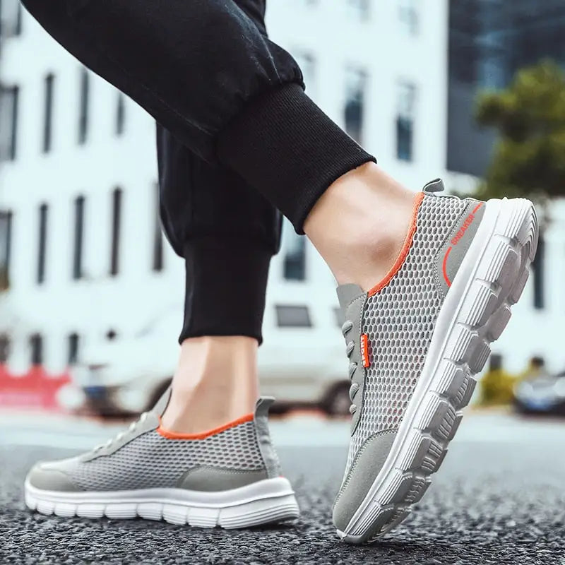 Men’s breathable mesh shoes with grey mesh, orange accents, and white soles