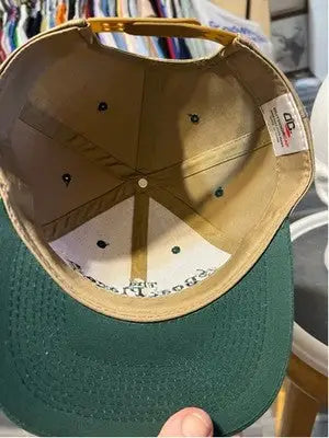 Upside-down tan and dark green outdoor cap baseball hat from The Boat Place