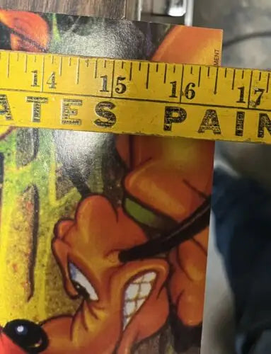 Pluto cartoon with measuring tape on Mickey Mania Timeless Adventures game poster