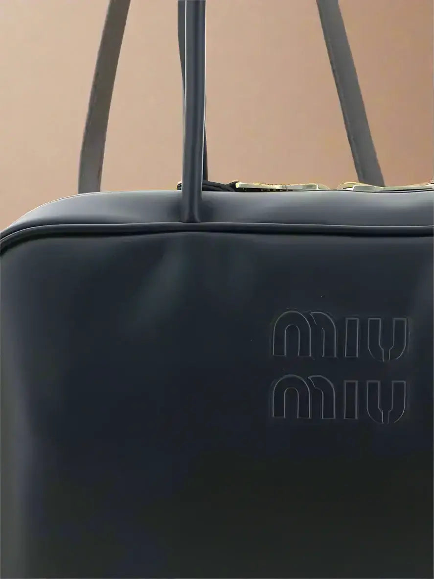 Black leather Miu Miu Beau tote bag with double-slider zipper closure and top handles