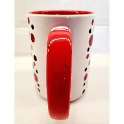 White ceramic coffee mug with red handle and unique polka dot design for NFL fans