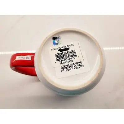 Red-handled ceramic coffee mug featuring a unique polka dot design and barcode sticker