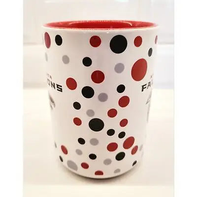 White ceramic coffee mug with red interior and unique polka dot pattern featuring NFL logo