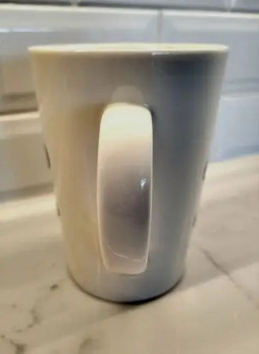 White ceramic coffee mug with New Orleans Saints logo, made of bone china