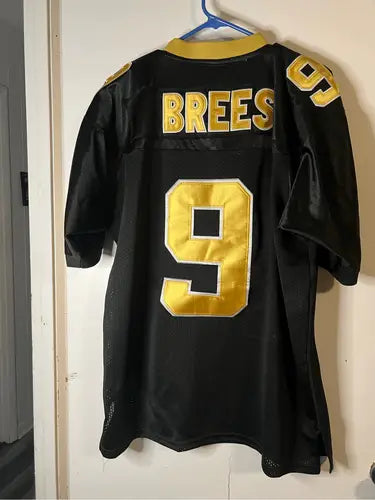 Black and gold Orleans Saints Drew Brees jersey with stitched number 9 for fans