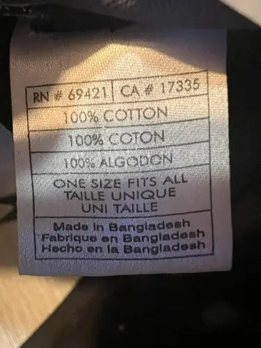 White garment care label with black text on New Orleans Saints NFL Hat for proper maintenance