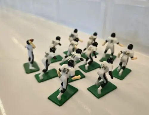 Miniature Jacksonville Jaguars electronic football players with QB and ball for electronic football games