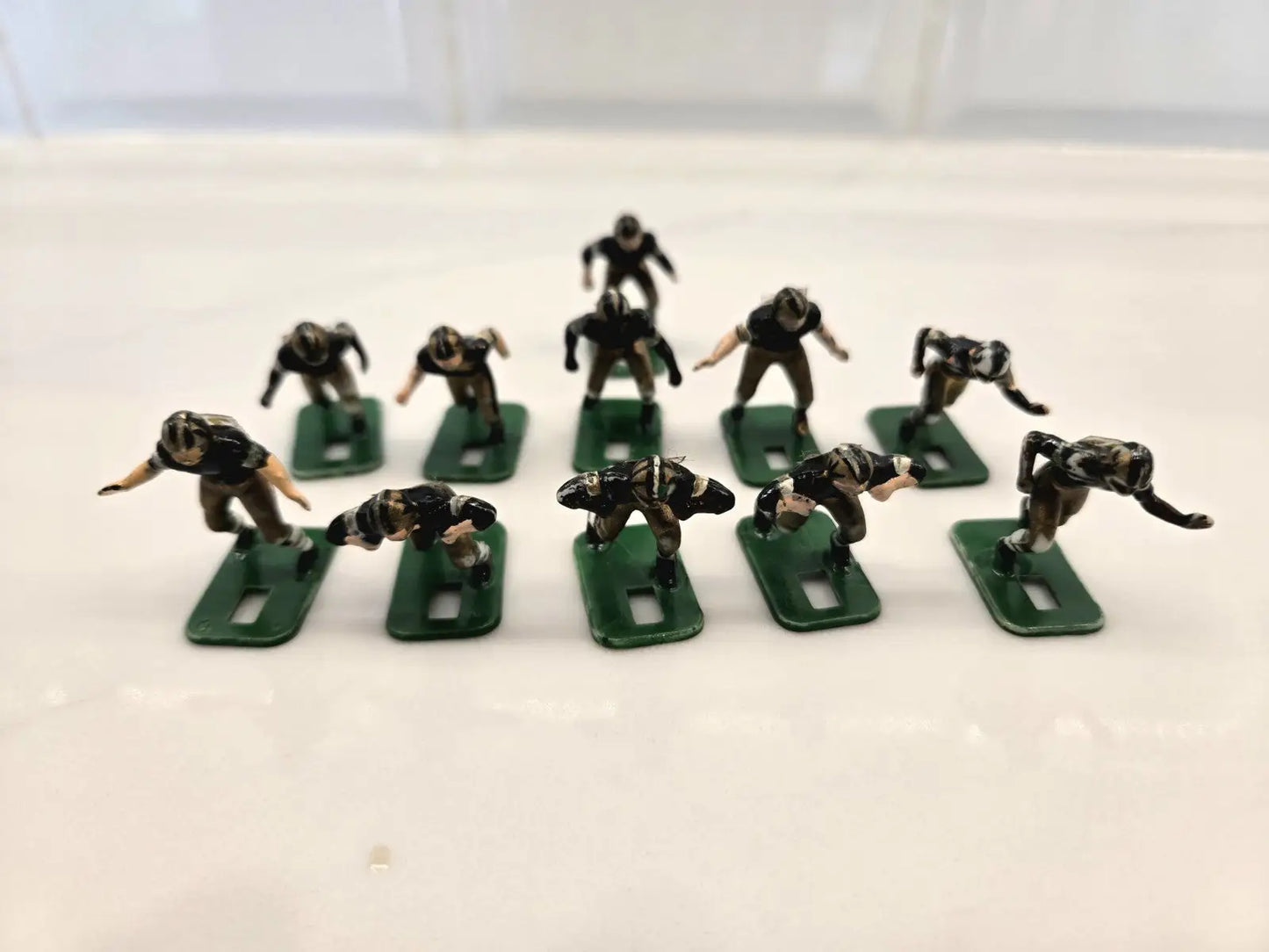 Miniature football players on green bases from Orleans Saints electronic toy set