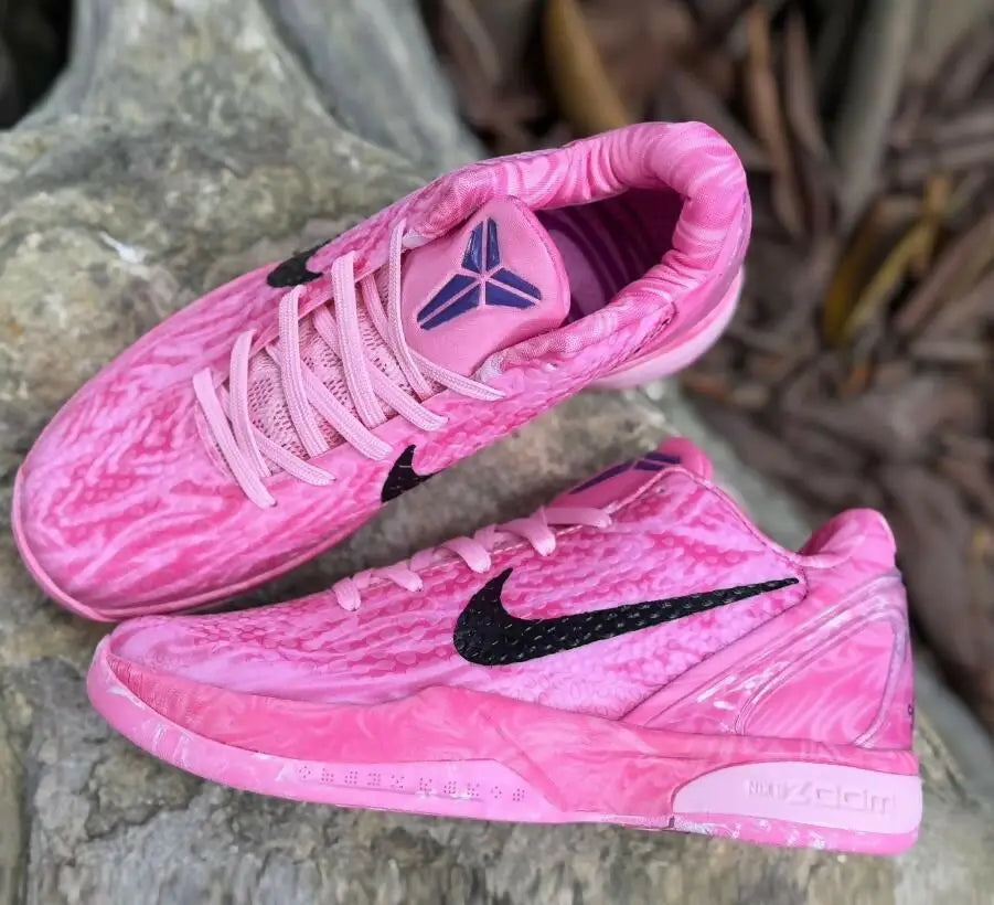 Vibrant pink Nike Kobe 6 Strawberry Milk athletic shoes with black swoosh and marbled pattern, fast shipping available