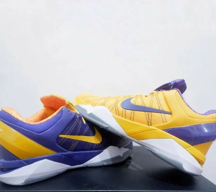 Multi-colored Nike Kobe 7 Yin Yang athletic shoes with purple, yellow, and white accents