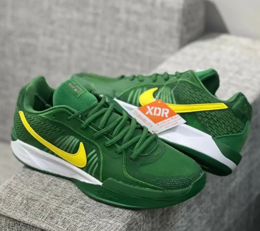 Green and yellow Nike Sabrina 2 Oregon athletic shoes with white soles, fast shipping