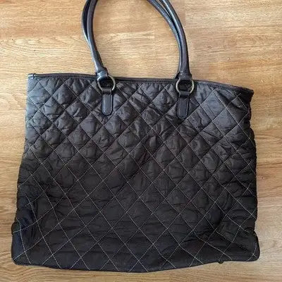 Navy brown quilted tote bag with two dark handles, casual shoulder purse