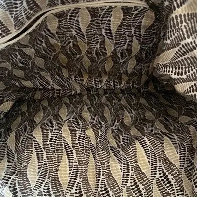 Textured fabric lining with black, white, and beige dotted pattern for navy brown quilted tote