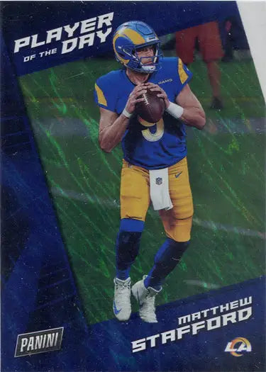 Football player in blue and yellow uniform holding football, featured in Silver Parallel trading card