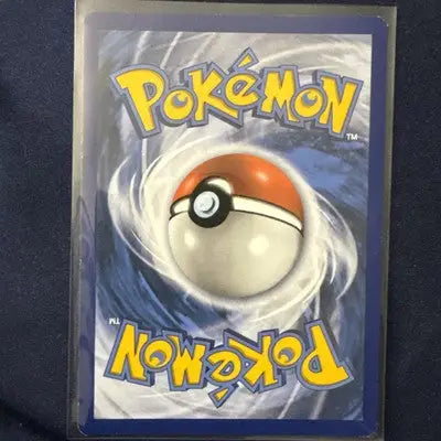 Sleeved Pokémon trading card with Poké Ball back, reverse holo rare, Evolving Skies Shelgon