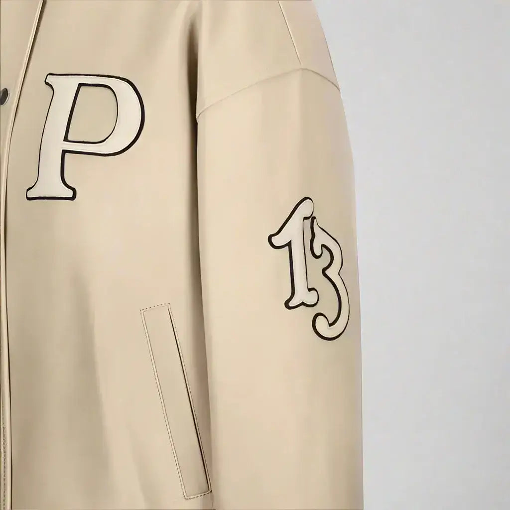 Beige PRADA women’s padded leather varsity jacket with P on chest and elasticated hem